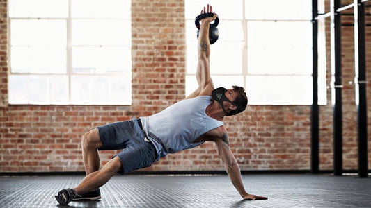 a guy on the gym working out using a kettlebell and a trainingmask