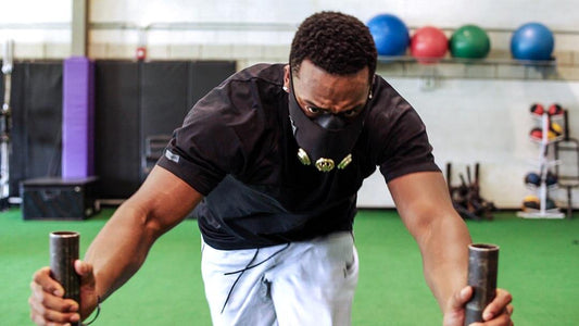 man pushing weights with training mask