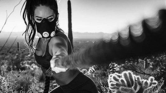 woman working out with ropes with her training mask