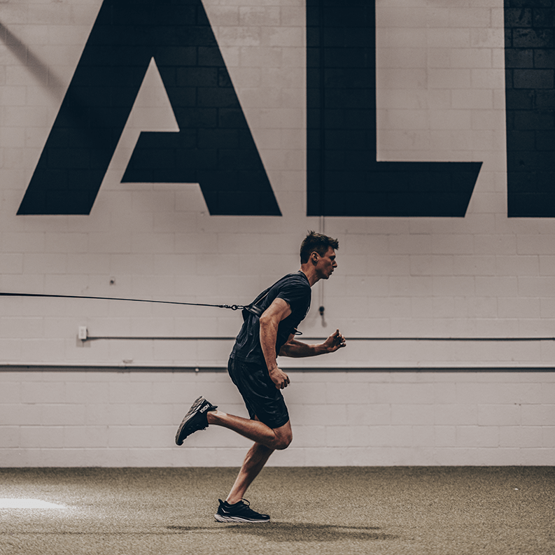 EpicBody Sled Vest + Strap- view of man running using strap