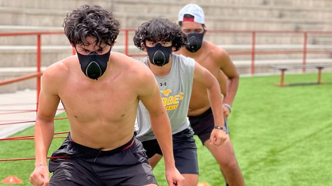 3 younng athletes doing a cardio workouts wearing a training mask