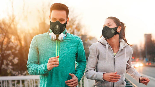 a male and female jogging on the street with trainingmask on