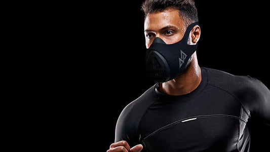 Man using training mask with dark setting in back