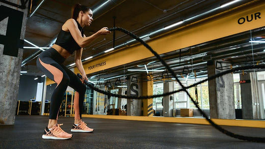 a female doing rope exercise in the gym