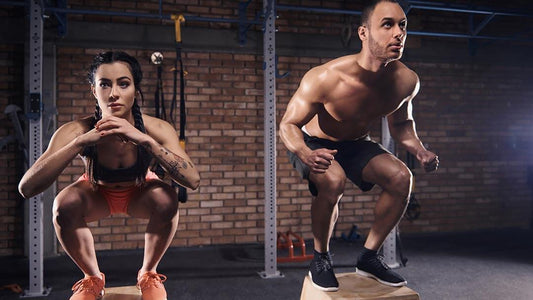 male and female working out, femal has ropes male is pulling on chains