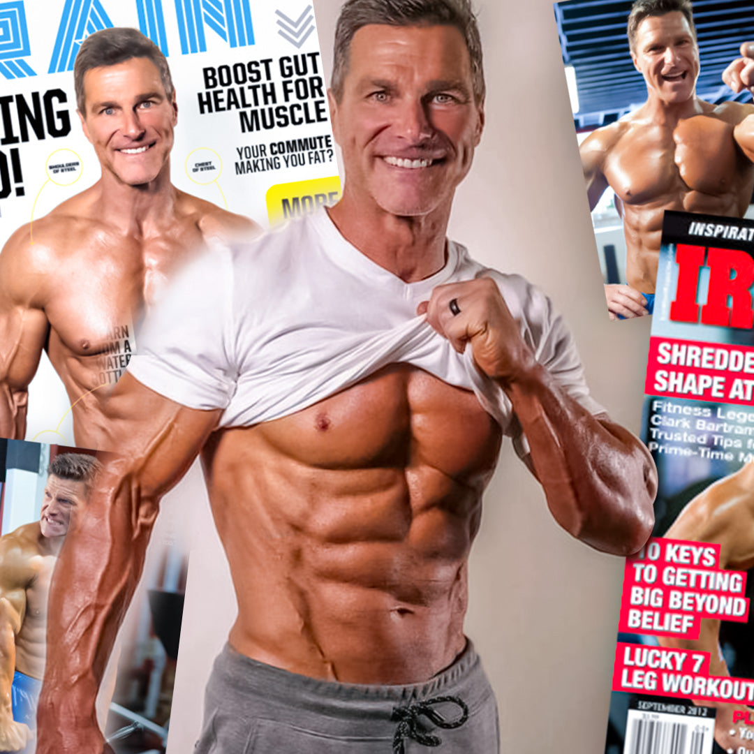 clark bartram flexing abs with magazine covers in background