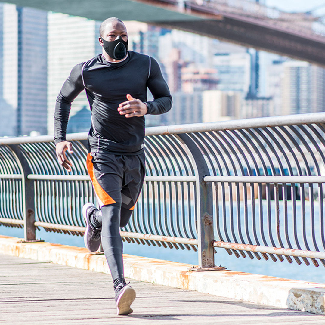 man running down street using Training Mask 3.0 for resistance breathing performance