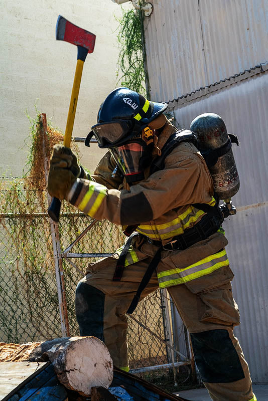 xrt pro being use by a fireman chopping wood